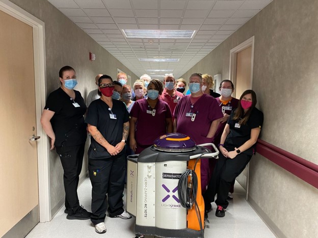 Members of the Unity Health White County Medical Center pose with one of their 10 LightStrike disinfection Robots -- this one is named Germinator!